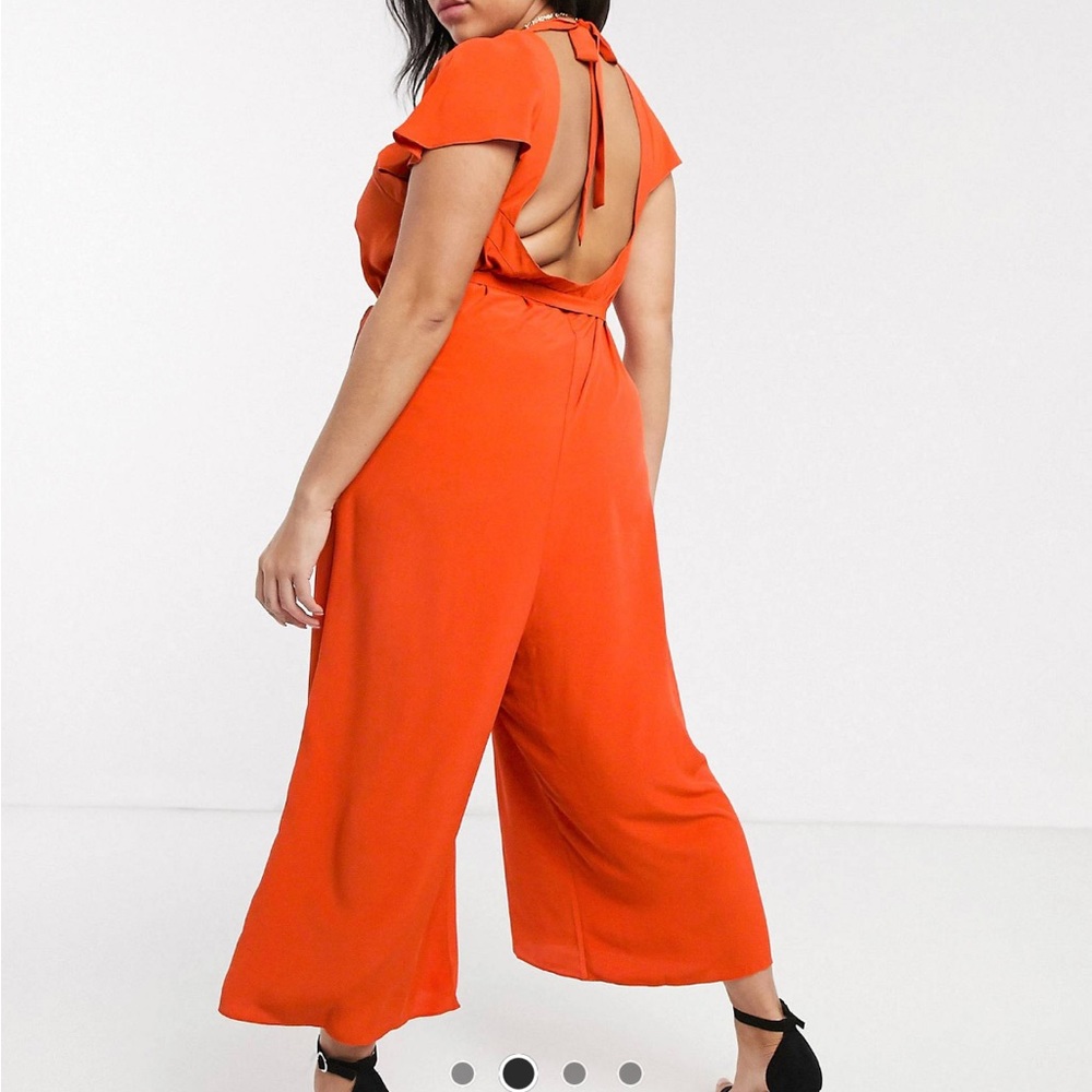 Lightly worn orange flowy jumpsuit with open back